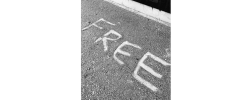Grafitti spelling out “FREE” on sidewalk