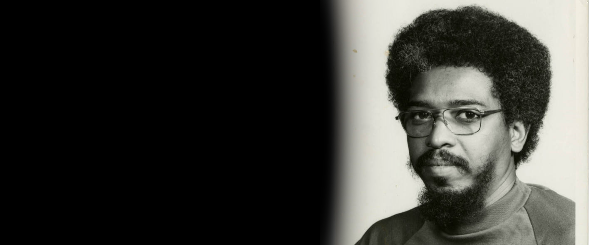 Black and white photograph of Professor John Scott Examining an Art Piece at Xavier University of Louisiana. 