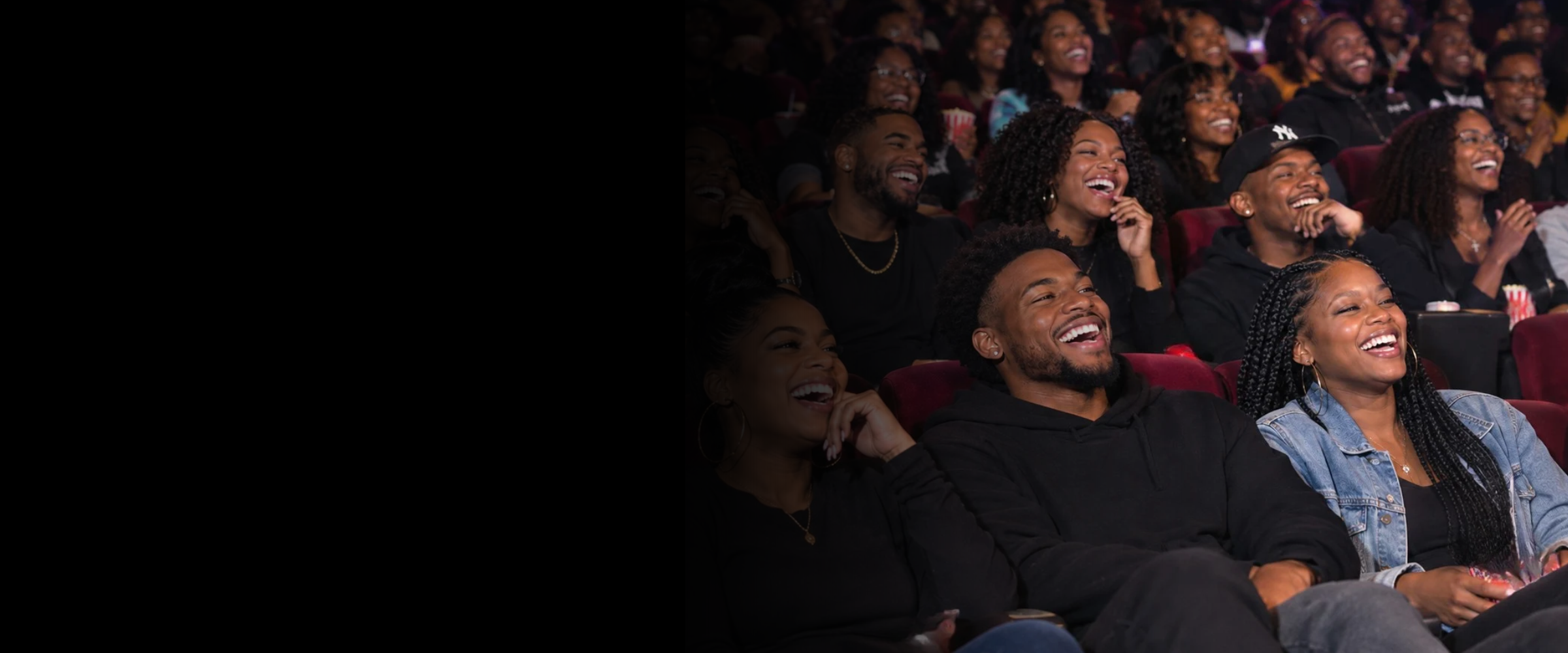 People in an audience laughing